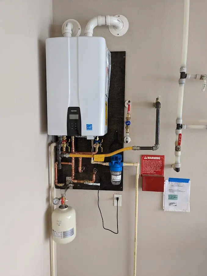 Professional plumber installing copper piping in a Fleetwood home